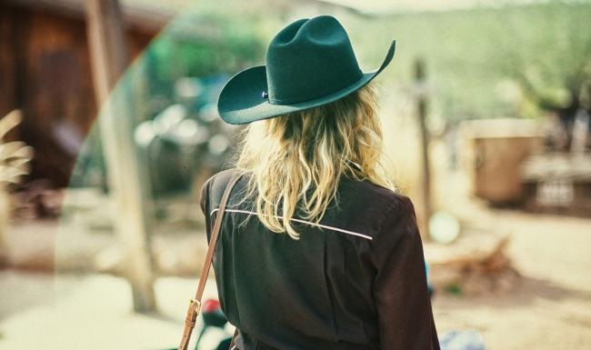 a woman with a hat and long hair